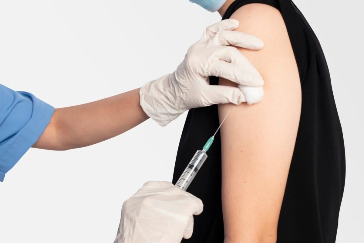 Pharmacist preparing a vaccine at Ryan's Pharmacy
